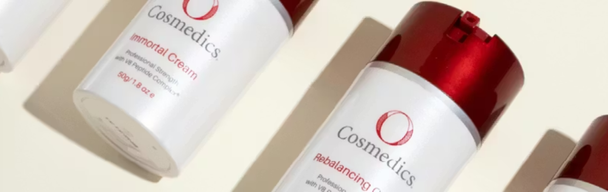 Cosmetic bottles with 'O Cosmedics' branding on a beige background