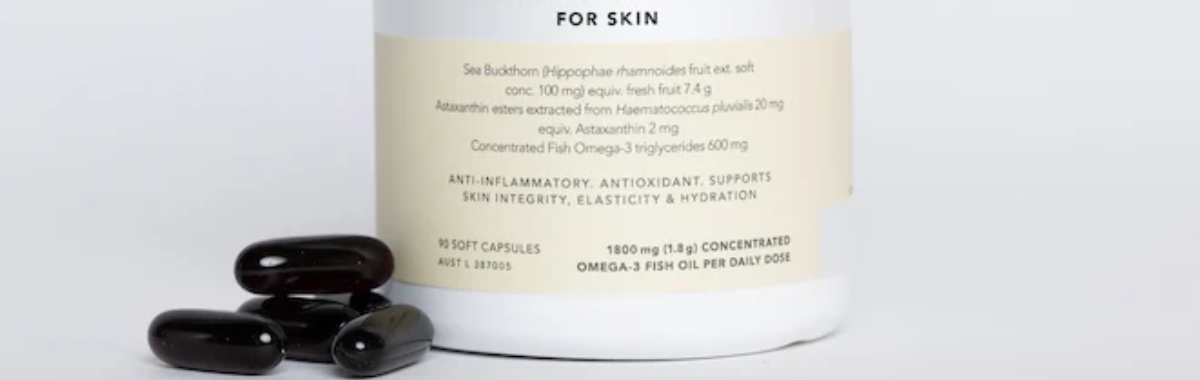 Supplement bottle with capsules on a white background