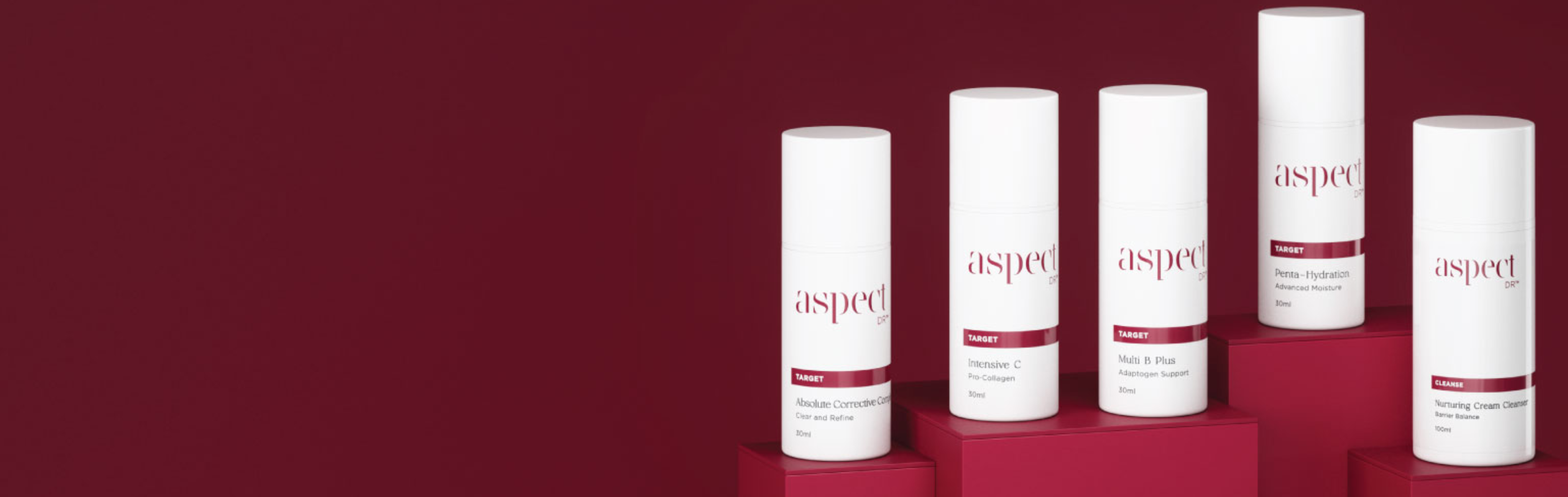 Five skincare product bottles labeled 'aspect dr' on a red background
