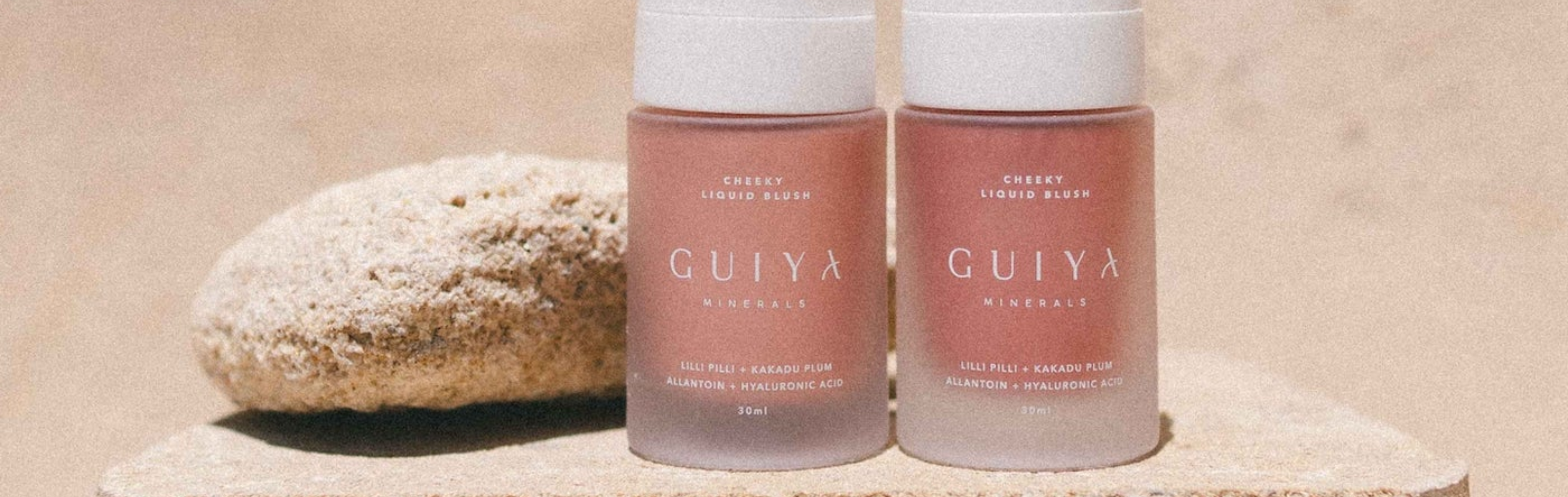 Two Guiya Mineral Blush bottles on a beige background