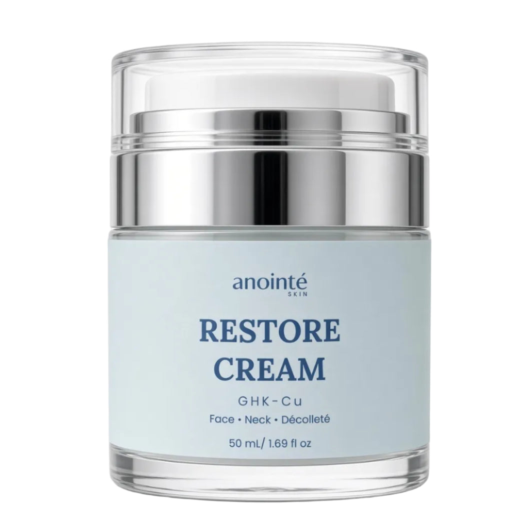 Anointé Restore Cream in a clear glass jar with a silver metallic collar and a pale blue label, set against a plain white background.